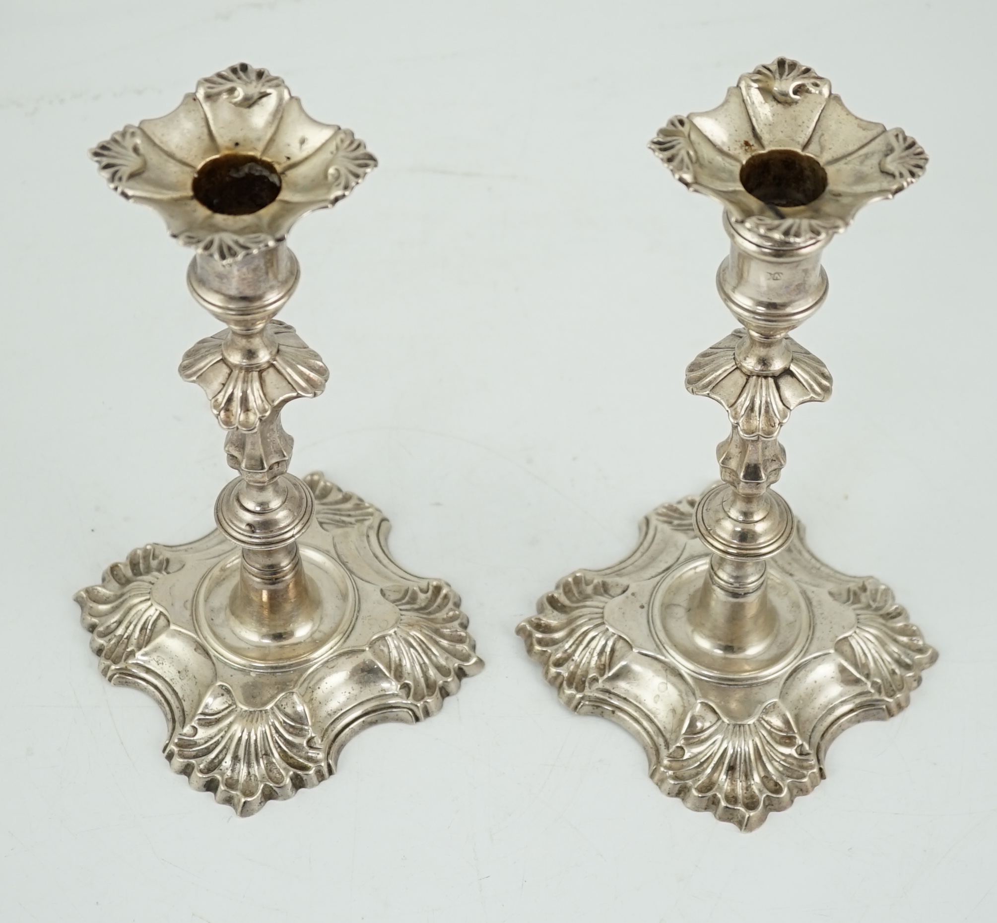 A pair of George II cast silver candlesticks by William Gould